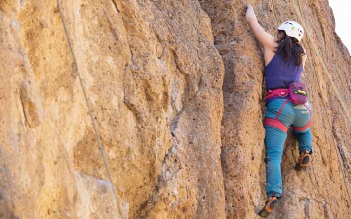 a student climbs a rock wall on an expedition with outward bound